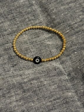 Gold Beaded Bracelet with Black Evil Eye Charm